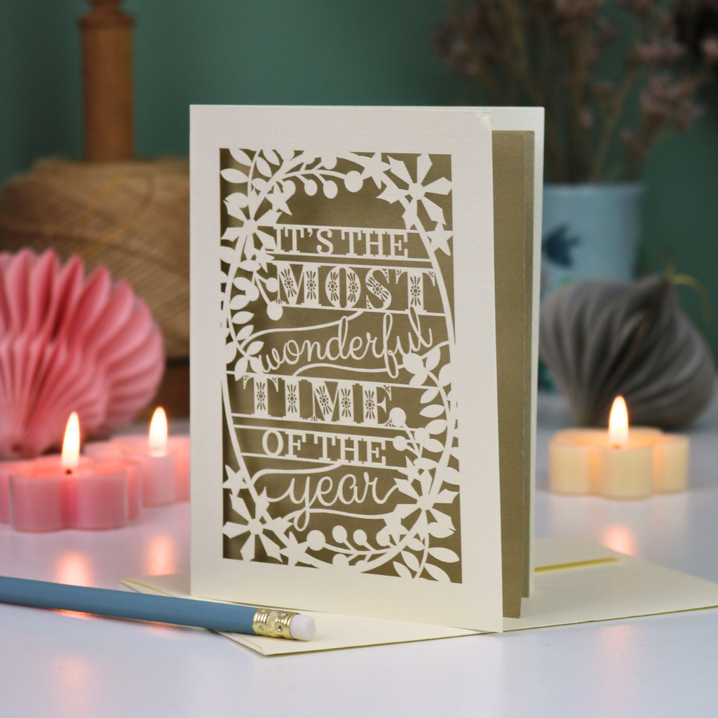 A laser cut Christmas card in cream with decorative text, 'It's the most wonderful time of the year'