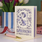 Decorative 3rd Birthday card with floral woodland and owl design, featuring the name 'Florence', on a table with a pen and flowers.