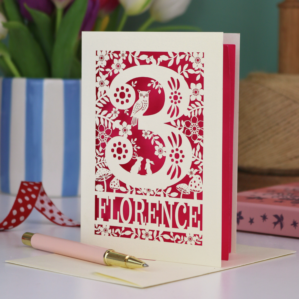 Decorative 3rd Birthday card with floral woodland and owl design, featuring the name 'Florence', on a table with a pen and flowers.