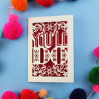  Laser cut  Valentine's card with 'YOU'LL DO' text on a blue background with colourful pom-poms.