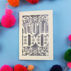 Decorative Valentine's card with 'YOU'LL DO' text on a blue background with colourful pom-poms.