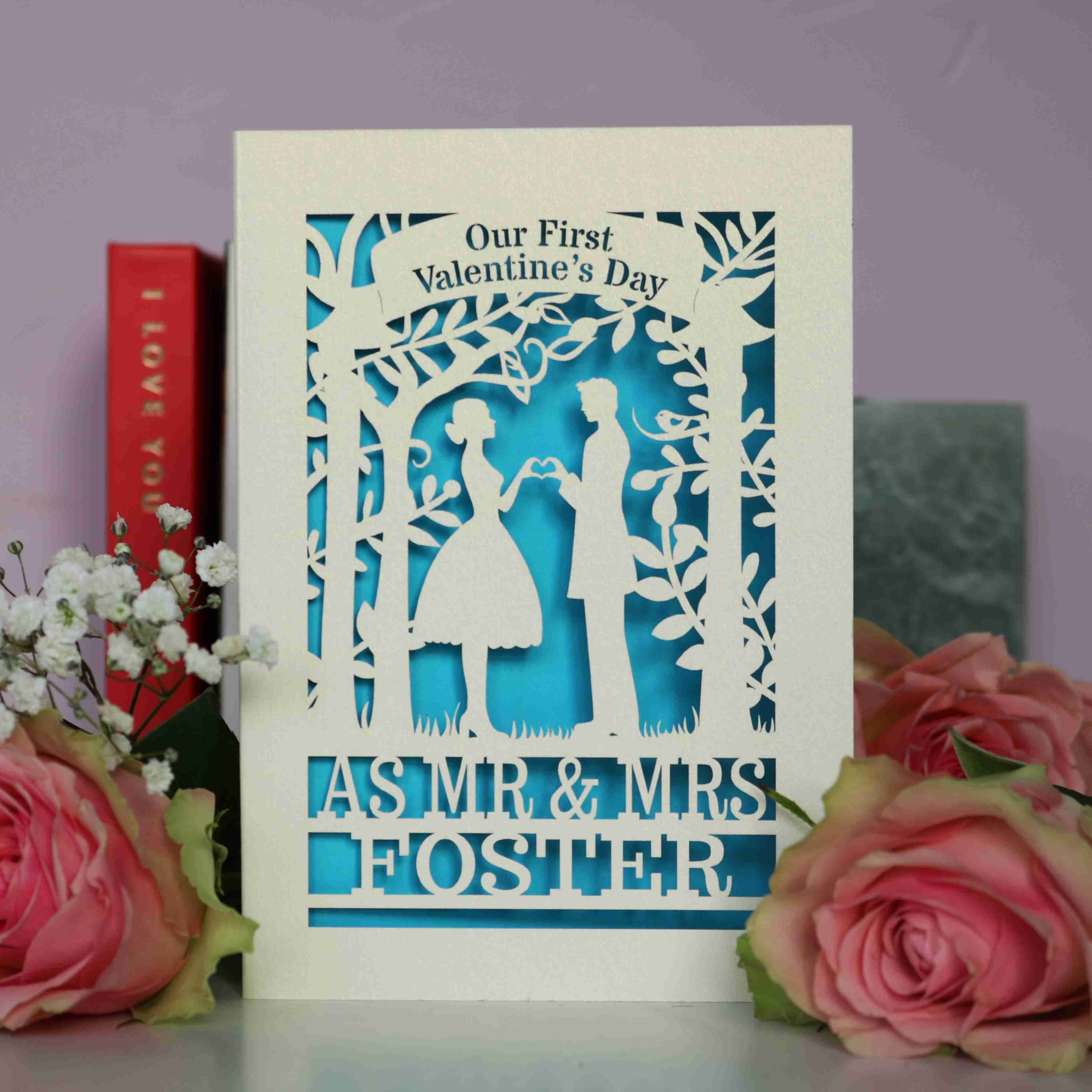 Personalised 1st Valentine's Day Card featuring laser cut couple making a heart with their hands, and the words "Our First Valentines Day as Mr & Mrs Foster"