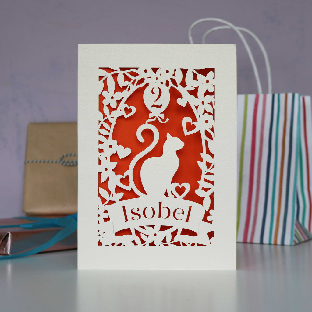 Cat and balloon design birthday card laser cut from cream card and finished with a red insert. Personalised with a name and age.