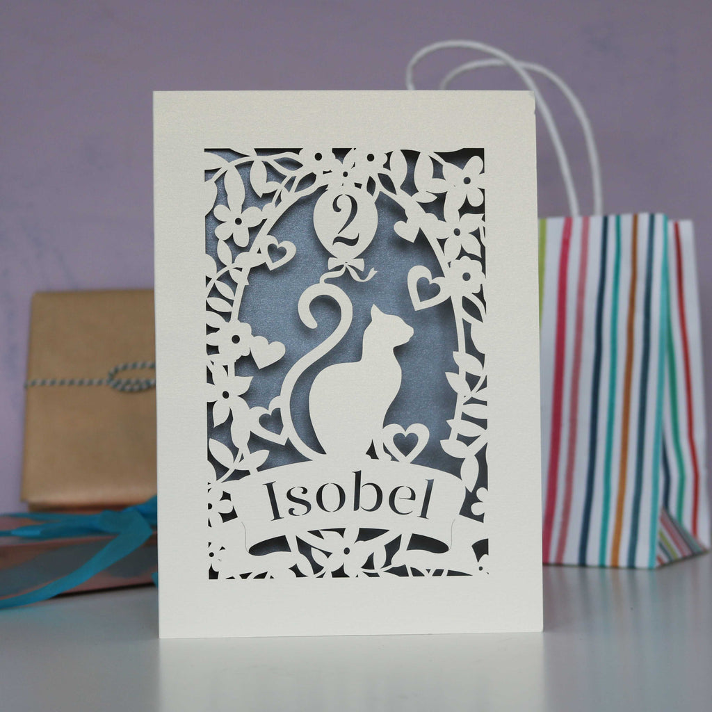 Stylish cat design laser cut birthday card. Shown in cream with a silver insert.  Personalise with a name and age.