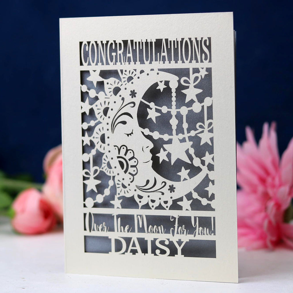A laser cut card for graduation, featuring a crescent moon and personalised with a name