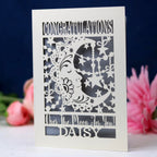 A laser cut card for graduation, featuring a crescent moon and personalised with a name