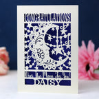 A laser cut congrats card with a crescent moon.