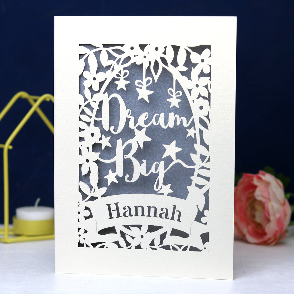 A personalised laser cut card with the words 'Dream Big' and a name 'Hannah' written on it