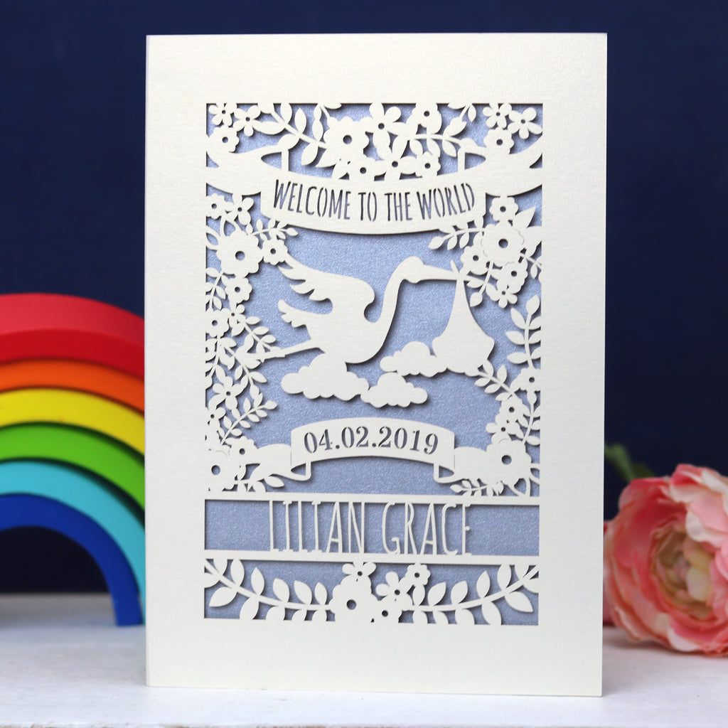 A "Welcome to the World" personalised card for new babies. This card is laser cut from cream card with a silver paper insert. 