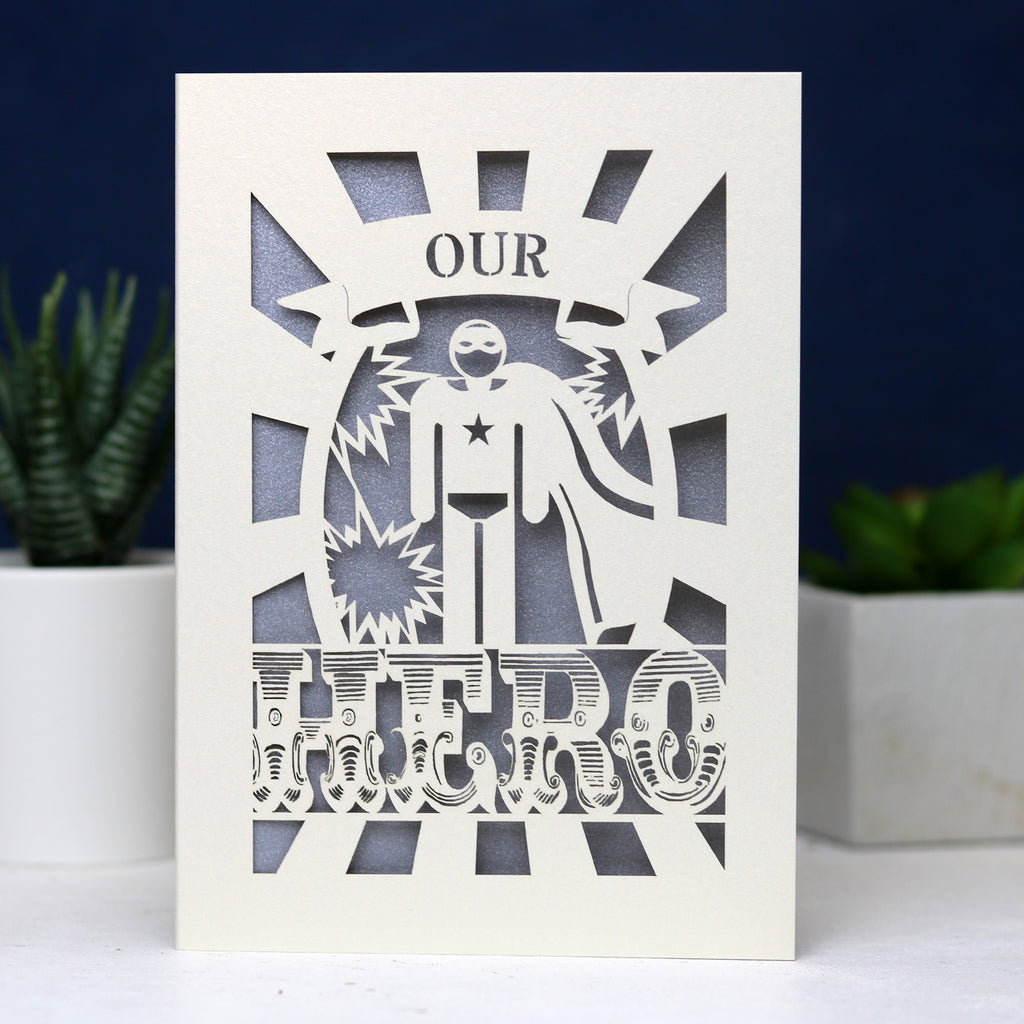 A paper cut UK Father's Day card featuring the words "Our Hero"