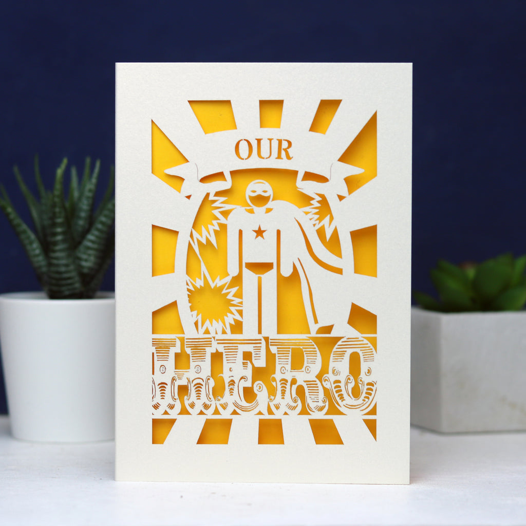 A paper cut UK Father's Day card featuring the words "Our Hero"