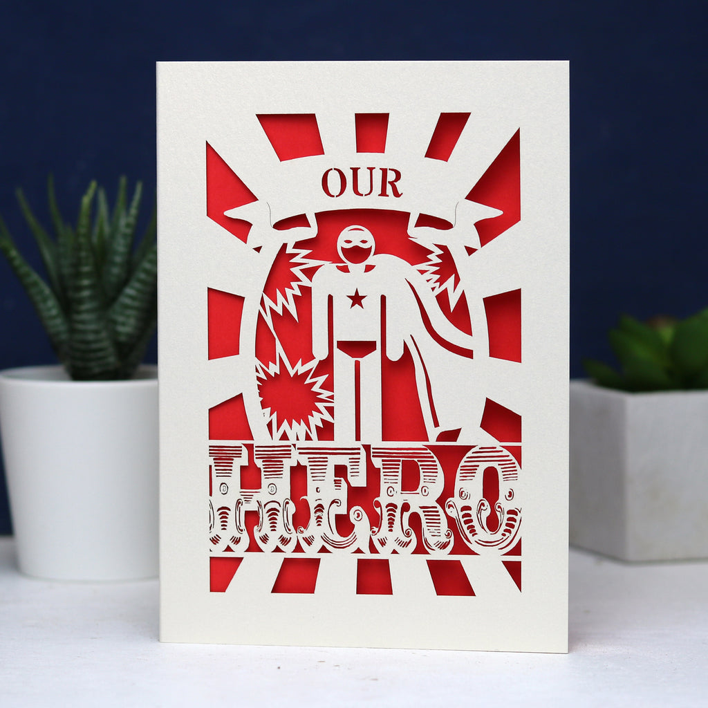 A paper cut Father's Day card that says "Our Hero"