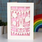 A laser cut card for a first birthday. This card is cream with a candy pink paper behind.