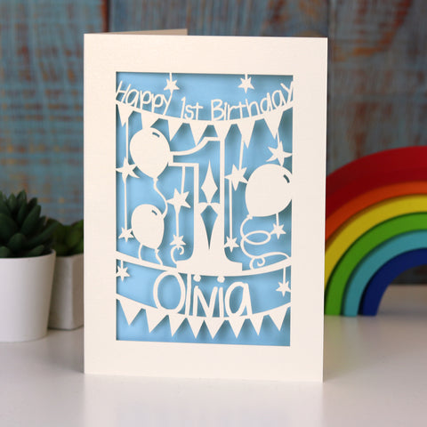 Something about a first birthday card. It's a laser cut card. It's very nice. I've written a lot of these today. It's got light blue paper. Buy it for your child or grandchild, niece or nephew. They will love it. Ok, they won't care. But their parents will love it.  - A5 (large) / Light Blue