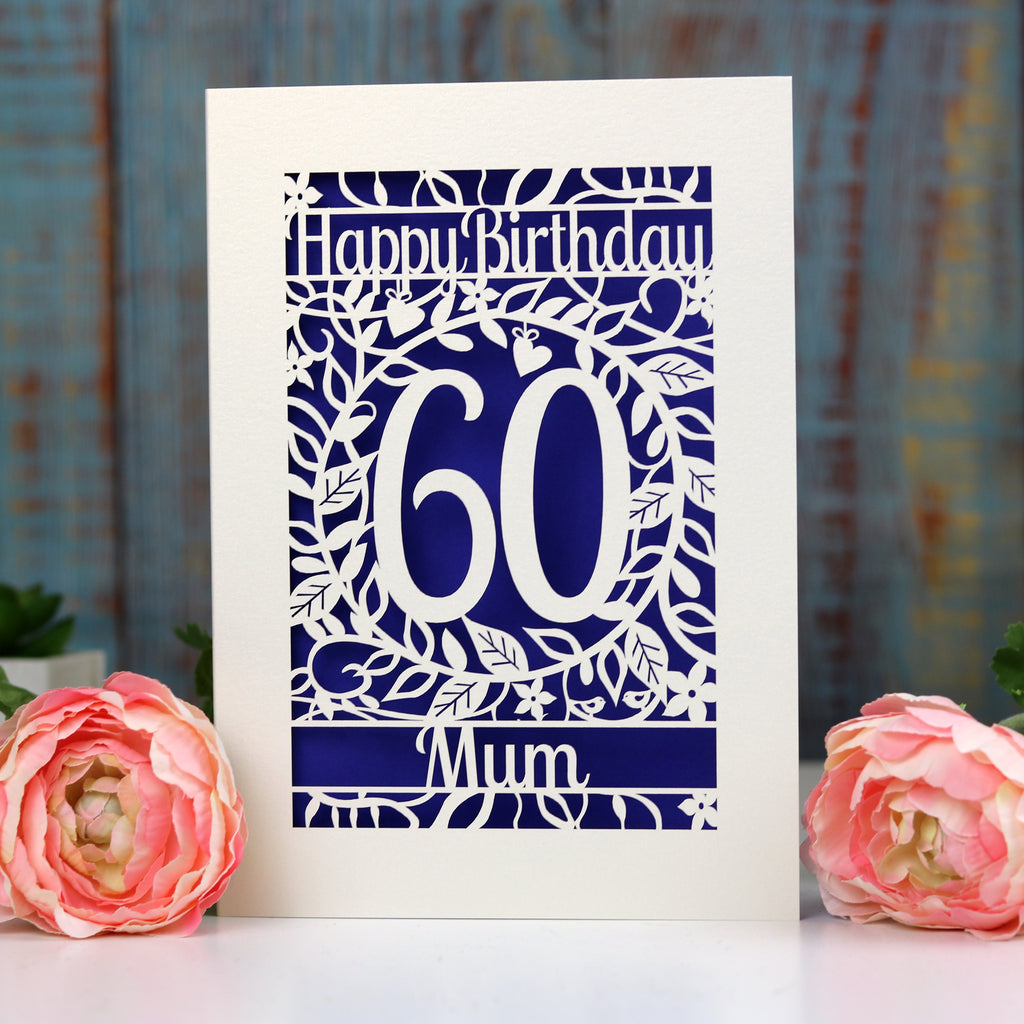 A 60th birthday card for Mum, laser cut from cream card with a deep violet paper insert behind the laser cut.