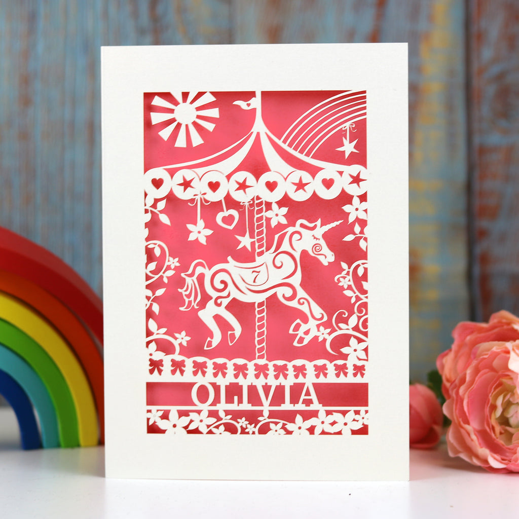 Personalised cards for girls birthday. This laser cut card has a merry go round horse and is personalised with a name at the bottom of the design and an age in the horse's saddle. 