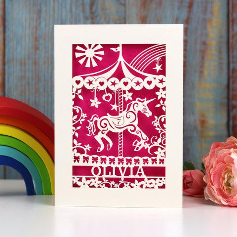 Paper cut birthday cards for granddaughters. This card shows a laser cut merry go round design personalised with a name and age. Card is cream and cut out to reveal shocking pink paper behind - A5 (large) / Shocking Pink
