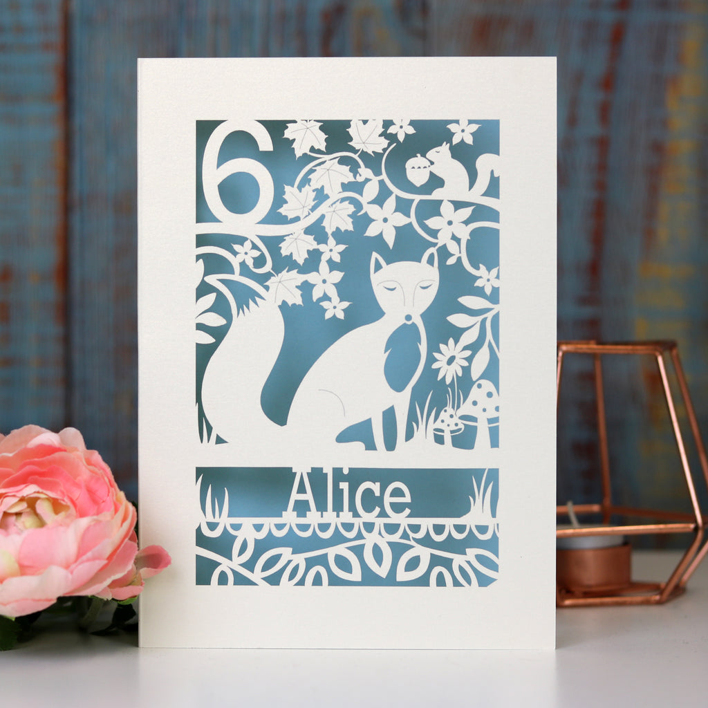Children's fox birthday card. Laser cut card with a light blue paper insert. Card is personalised with a name and age