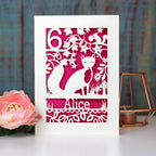 A personalised birthday card with a fox and a name. Card is cut away to reveal a shocking pink paper behind