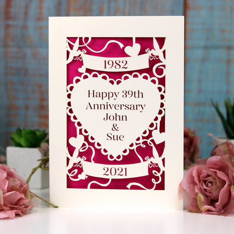 A papercut anniversary card with names and number of years cut from a cream card. The paper behind is shocking pink. - A6 (small) / Sshocking pink