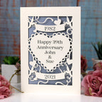 An anniversary card laser cut from cream card and personalised with anniversary details. 