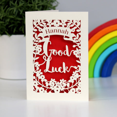 Good Luck personalised laser cut card. Shows the words Good Luck , flowers and a banner all cut from cream card and finished with a bright red insert paper. - A5 / Bright Red