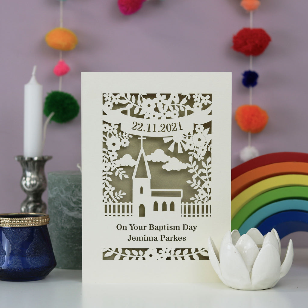 A laser cut card for Baptisms. Personalised with a name and date, with a church surrounded by flowers 