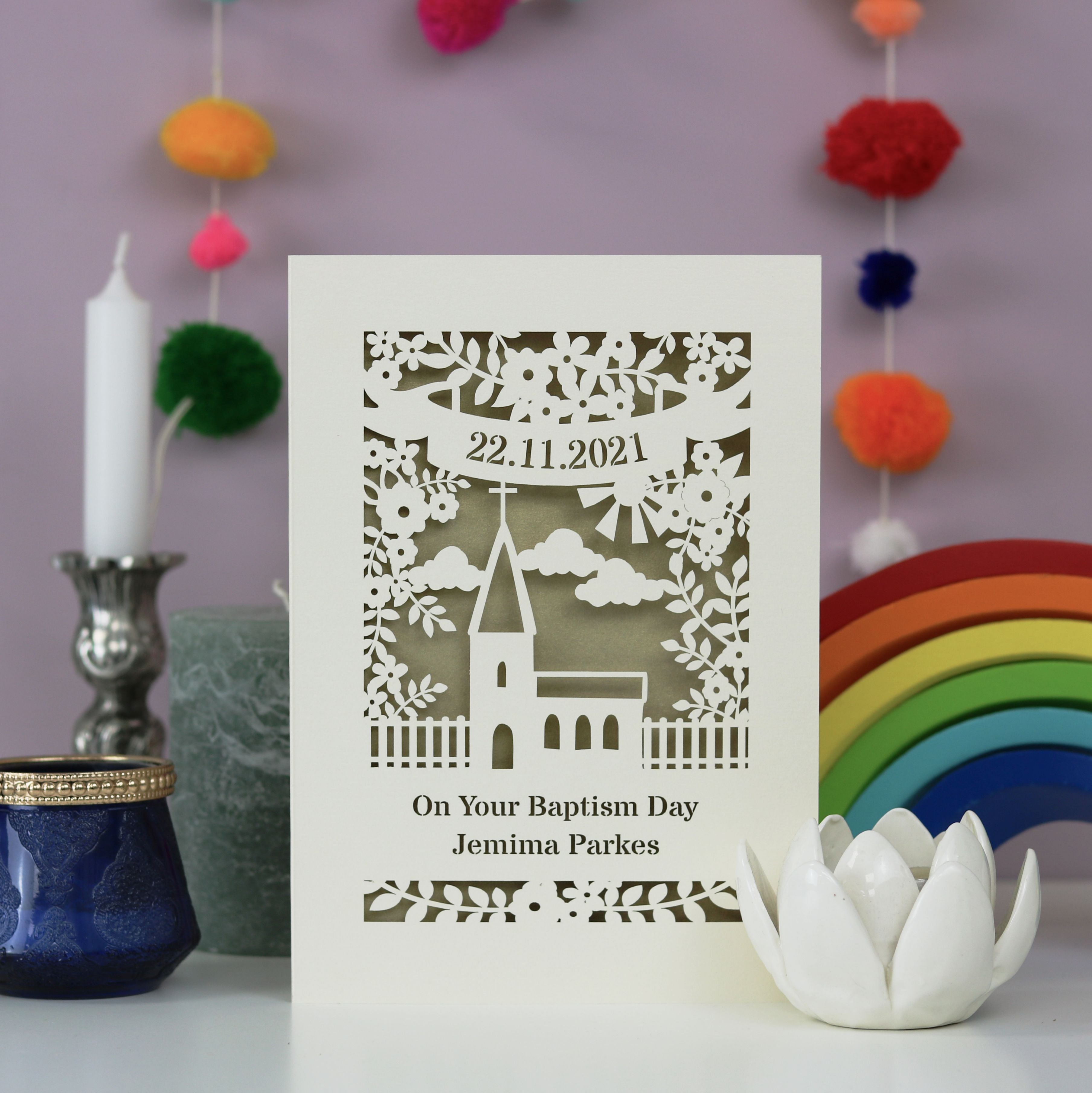 A laser cut card for Baptisms. Personalised with a name and date, with a church surrounded by flowers 