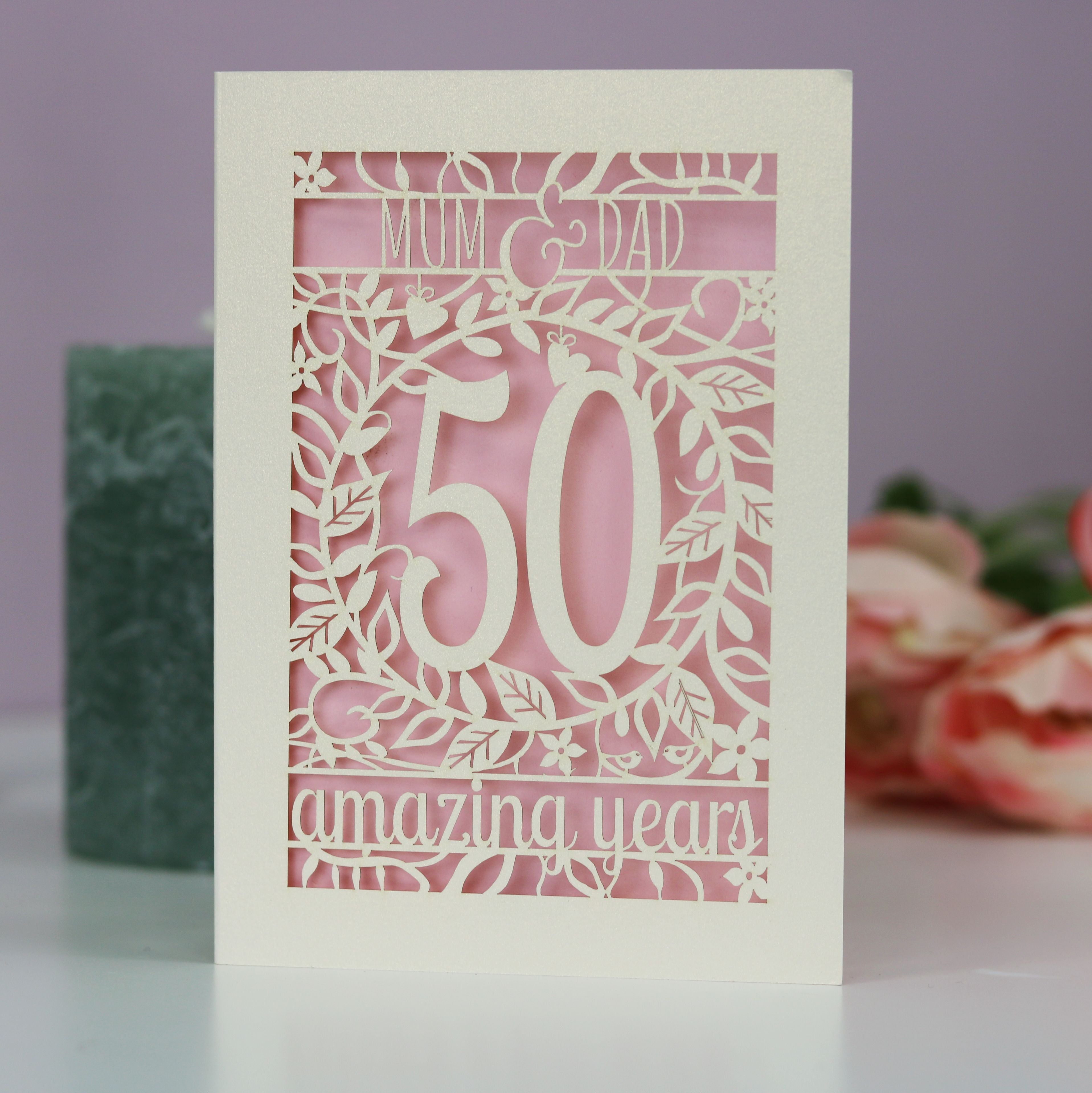 A 50th anniversary card for Mum & Dad. Card is laser cut and reads Mum & Dad, 50 amazing years.