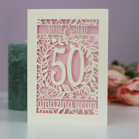 A 50th anniversary card for Mum & Dad. Card is laser cut and reads Mum & Dad, 50 amazing years. - A5 / Candy Pink
