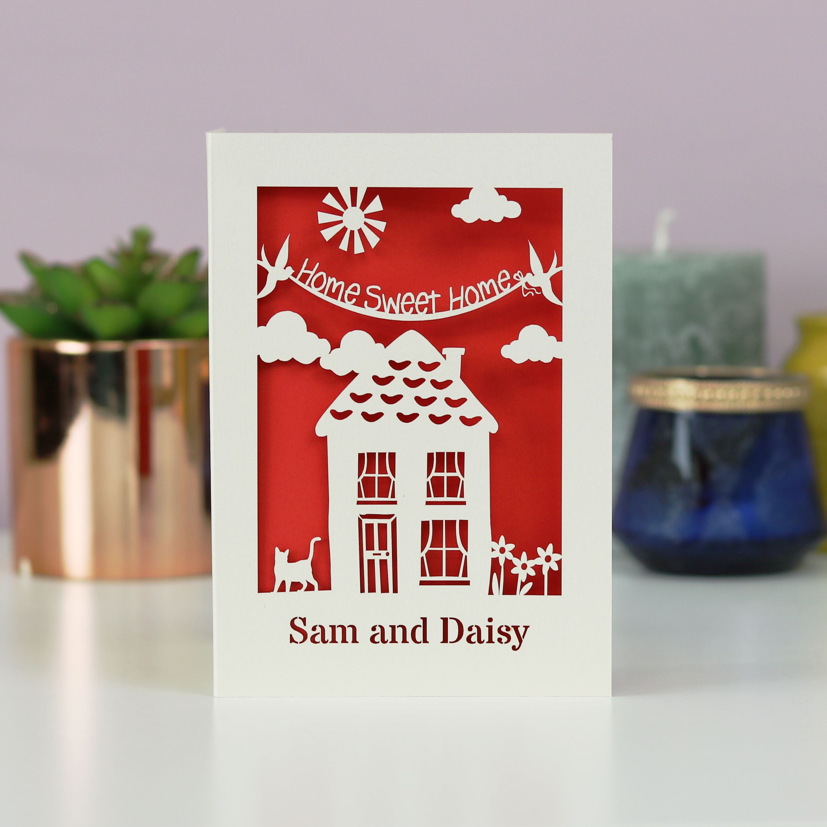 New home card features a laser cut house illustration and the words "home sweet home."