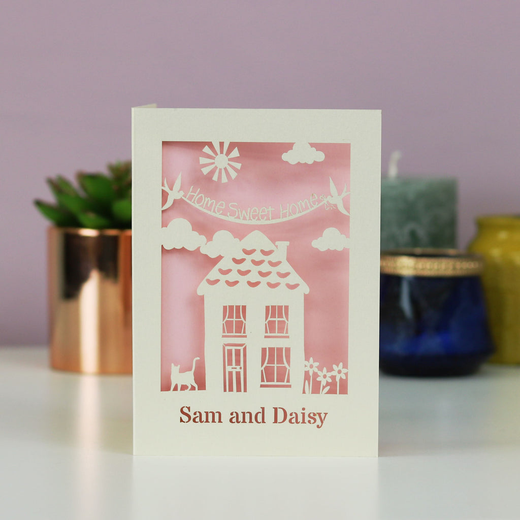 A house moving card with a house, the words "home sweet home" and the recipient's name. 