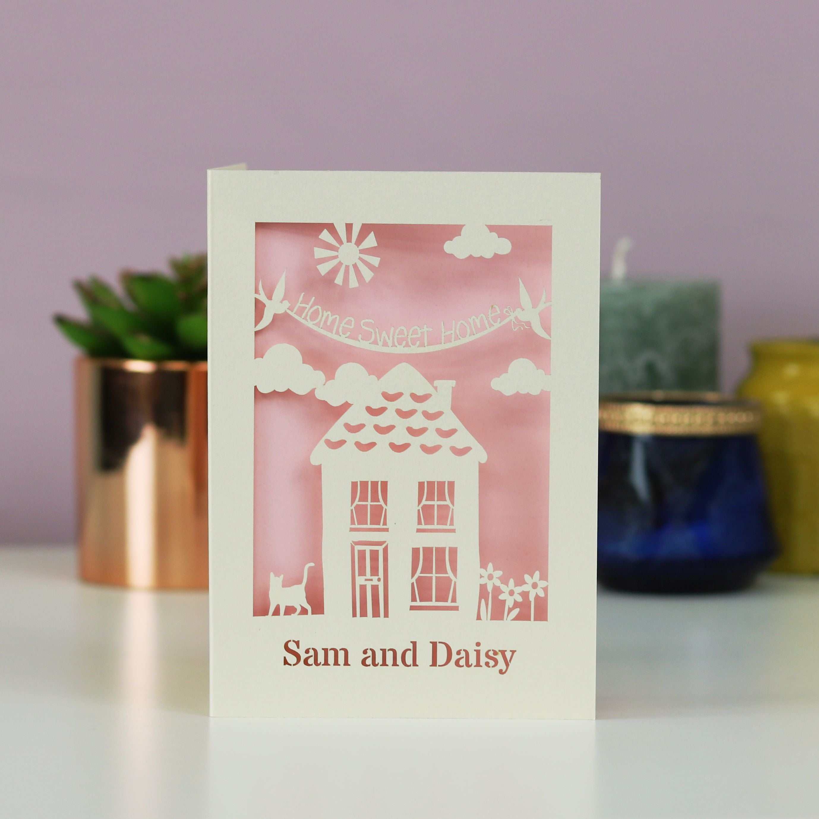 A house moving card with a house, the words "home sweet home" and the recipient's name. 