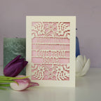 A paper cut First Mother's Day card with cut out text that says "Happy First Mother's Day, love from" and is personalised with a name