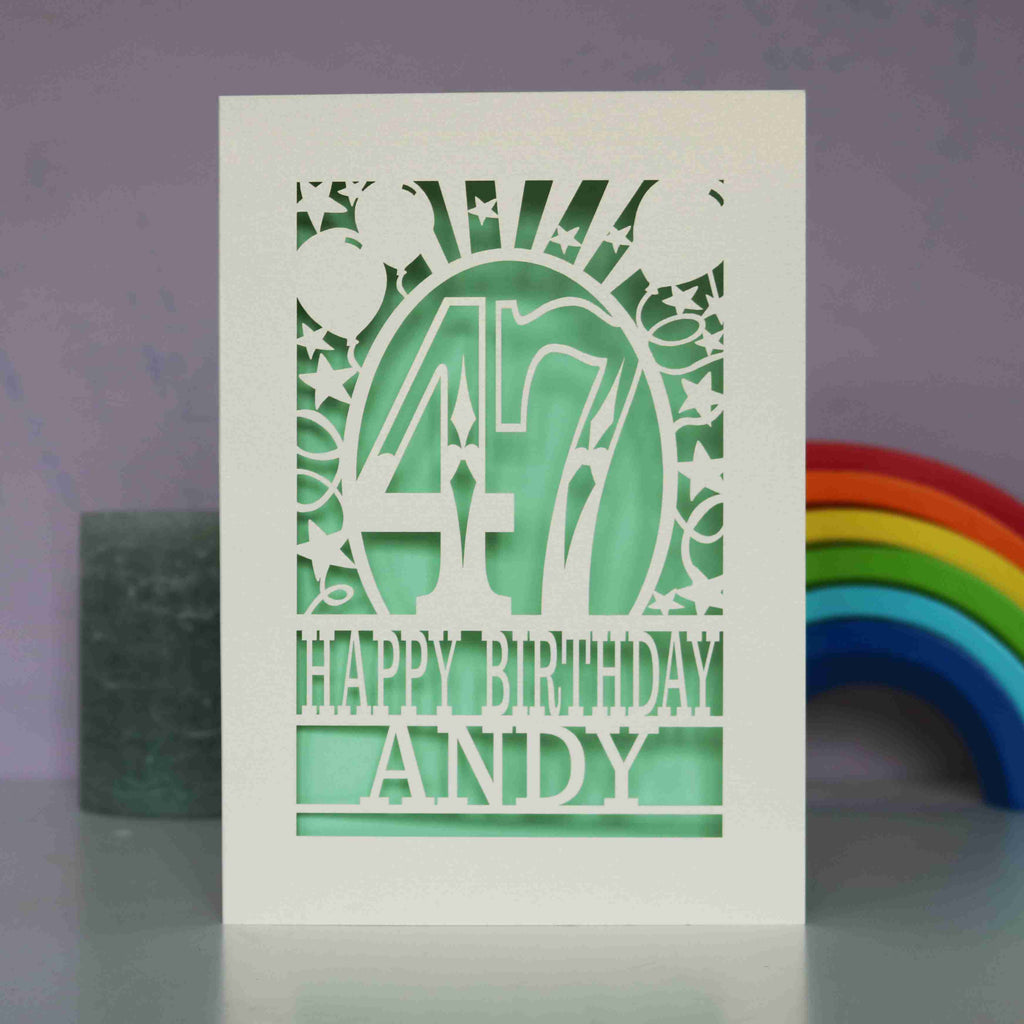 A laser cut cream and light green personalised birthday card 