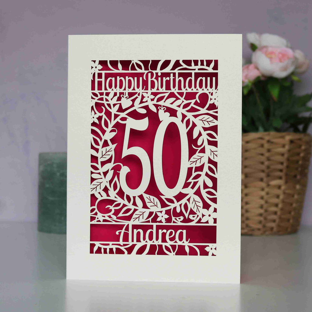 A laser cut birthday card for friends or family. Personalised with an age in the centre and Happy Birthday and a name. This image shows cream card and shocking pink paper.
