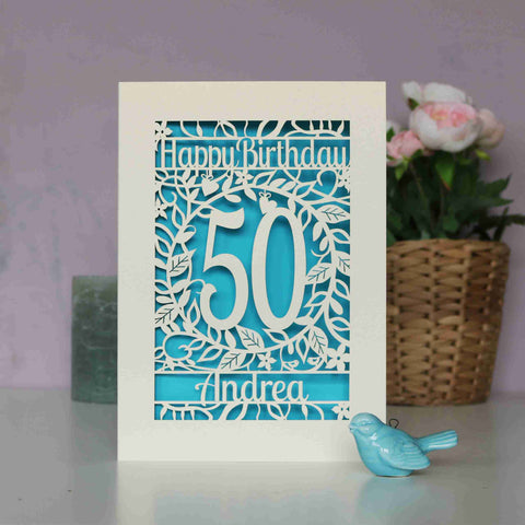 A laser cut birthday card personalised with an age and name. Blue paper shows through the cut design. - A5 / Peacock Blue