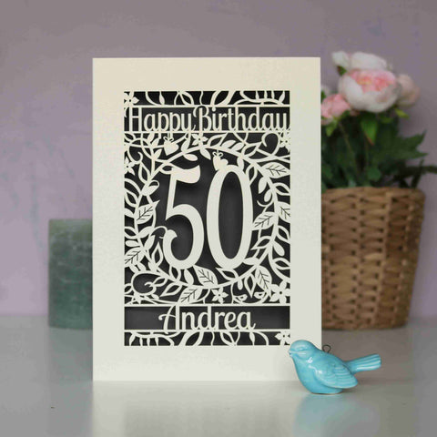 A cream and grey laser cut birthday card with flowers and leaf shapes. Card says "Happy Birthday, 50, Andrea" - A5 / Urban Grey