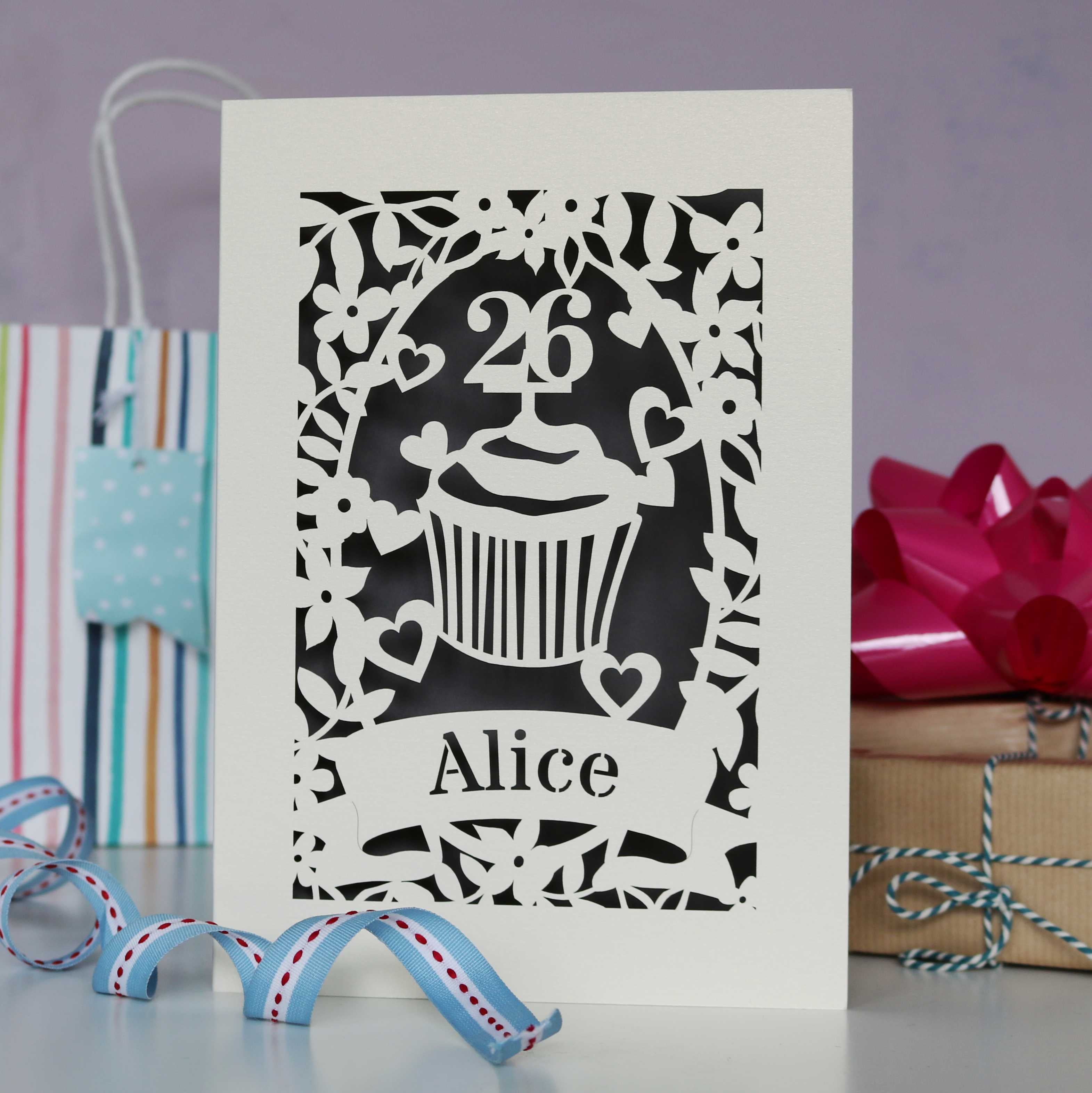 Beautiful personalised laser cut birthday card, perfect for mum, sister, girlfriend  or anyone who likes cake. Shows a cupcake with an age topper , lasercut from cream card and finished with an urban grey insert. Can be personalised with name and age.