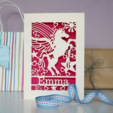Image shoes a paper cut unicorn birthday card, personalised with a name and age - A5 / Shocking Pink