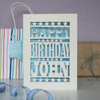 Personalised paper cut birthday card for him. Cream and light blue, personalised with a name. 