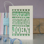 A laser cut birthday card for husband. Card is cream with laser cut shapes to form words-Happy Birthday Name".