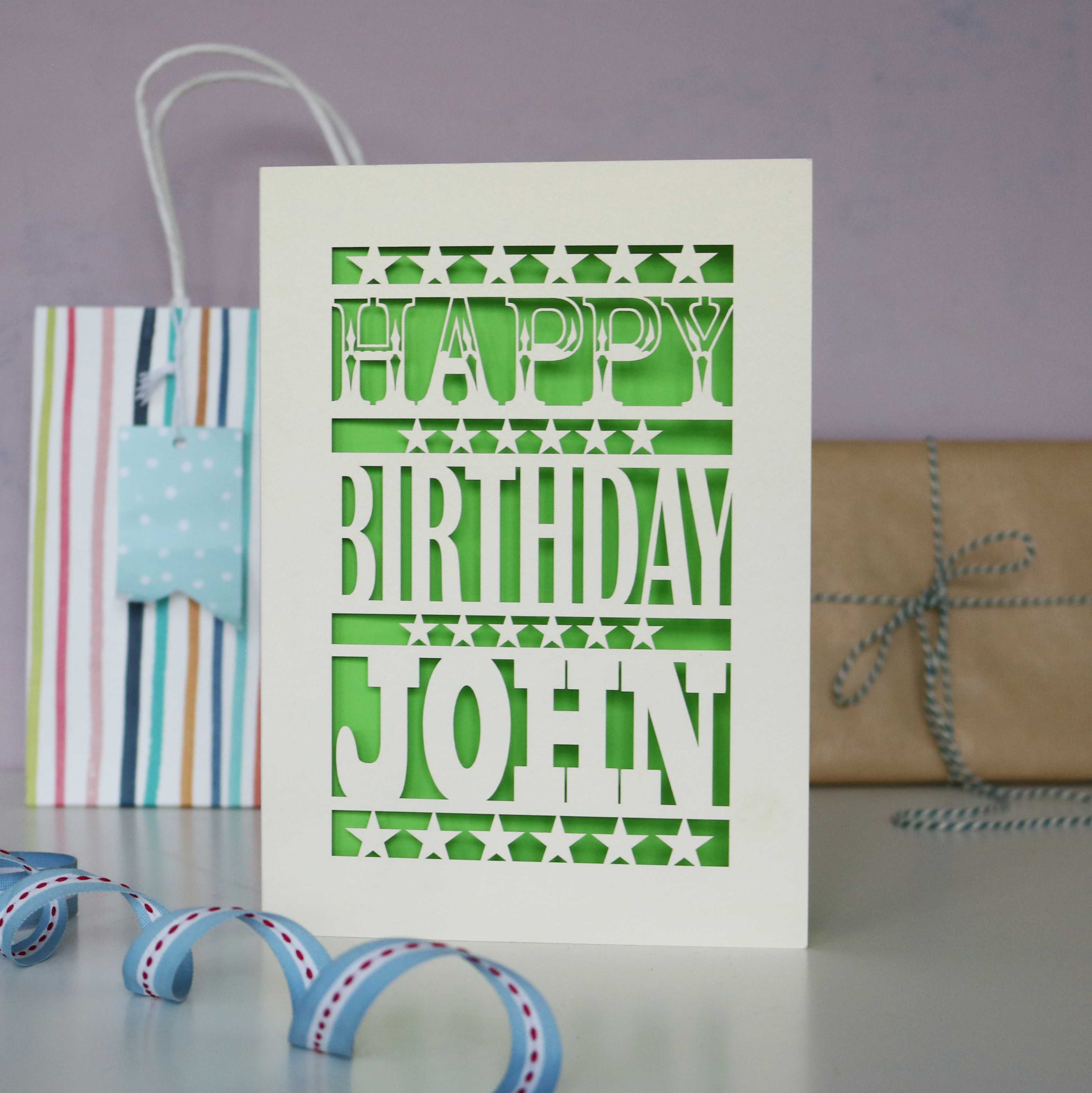 A cream laser cut birthday card personalised with a name. 