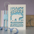 Pale blue background and cream laser cut card showing a bear in the woods.  Can be personalised with a name and optional age.