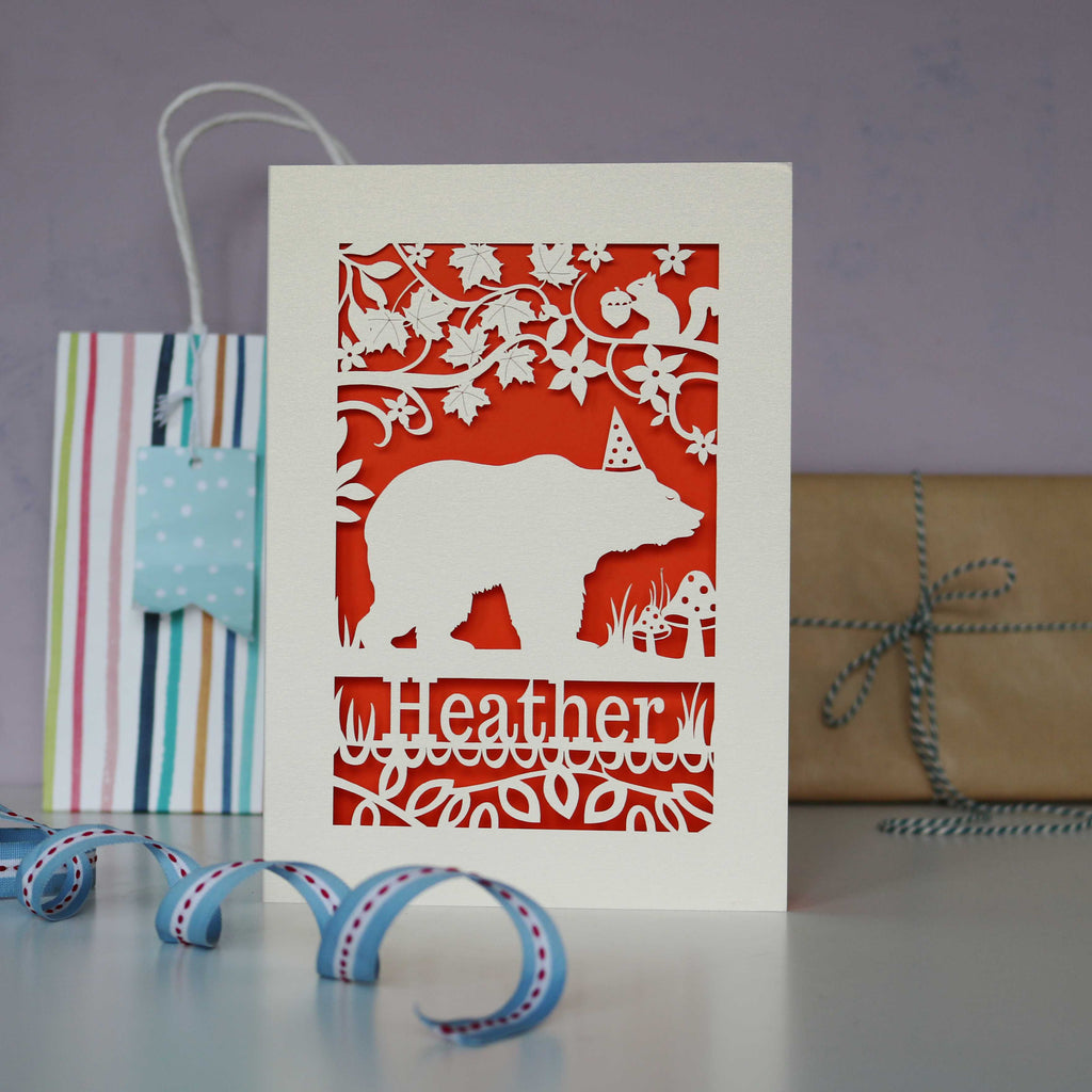Personalised laser cut bear design birthday card. Can be personalised with a name and age (optional). Laser cut from cream card with an orange insert paper.