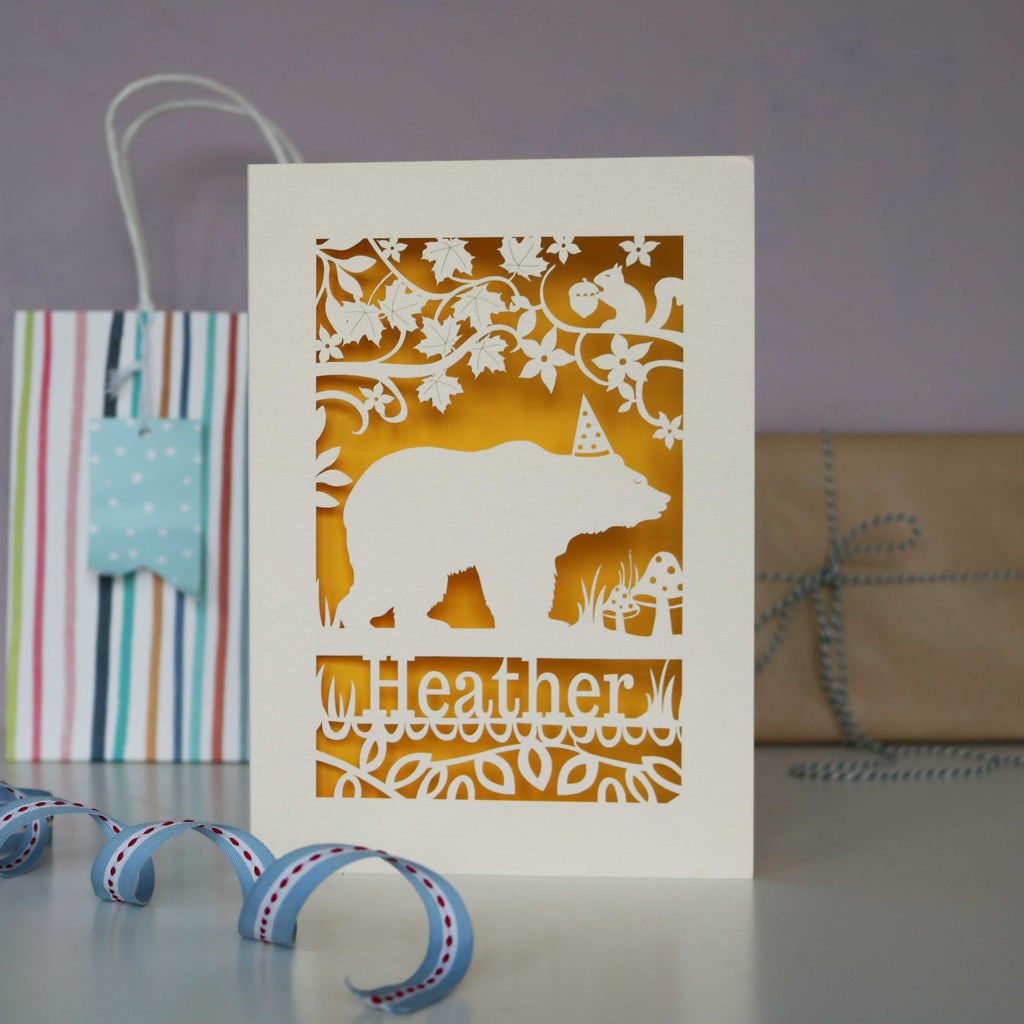 Bear in a hat birthday laser cut card cut from cream card with a sunshine yellow insert. Personalise with a name and age.