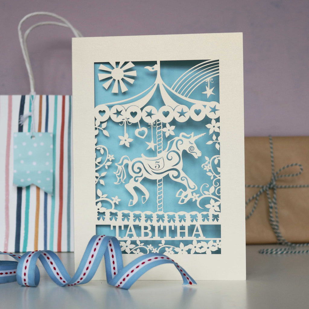 A personalised card for a little girl's birthday. Laser cut with a unicorn carousel
