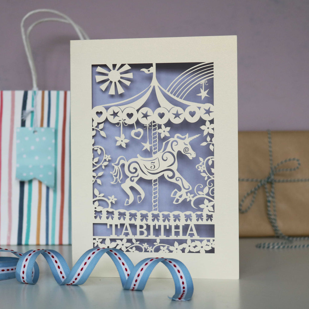 A personalised laser cut birthday card with a horse and carousel.