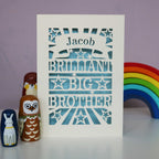 A laser cut big brother card, personalised with a name in a banner and the words "Brilliant Big Brother"