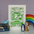 A cream and bright greet baby card. Border and cut design are cream with a bright green background. "Welcome to the World" is in the top of the design, a stork, leaves and flowers in the centre and at the bottom is the date of birth and baby's name.